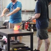 Students demonstrate glass blowing