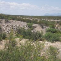 Wide, steep-sided channel and rubble indicate a flash flood channel